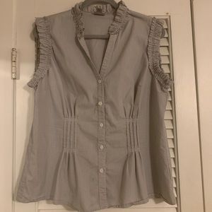 Cute sleeveless button-up with ruffle details